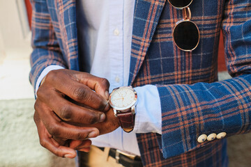 Businessman adjusting wristwatch time