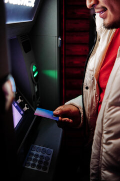 Young Man Using Debit Card At ATM