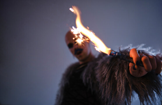 Man holding firework against gray background