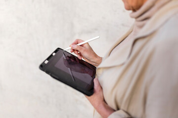 Mature woman using digital tablet