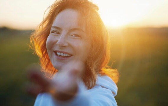 Smiling redhead woman enjoying during sunset