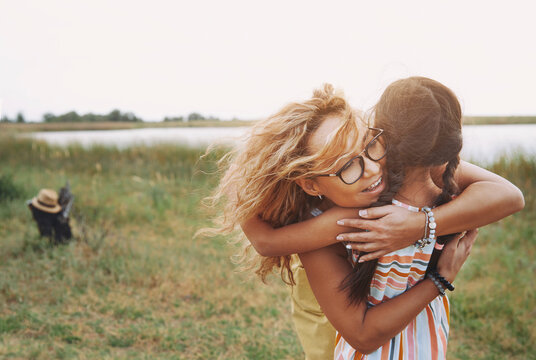 Blond mother embracing daughter