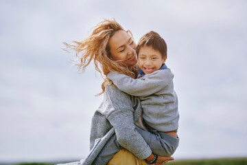 Mother carrying happy son with down syndrome