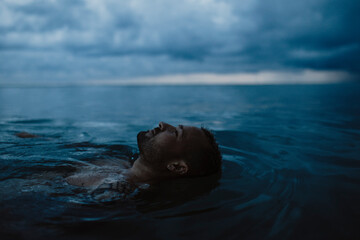 Man floating on water in sea