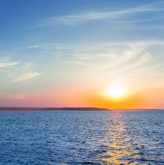 Naklejka na ściany i meble dramatic sunset over the quiet sea bay
