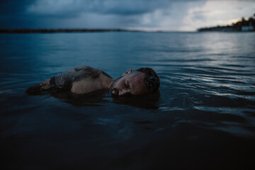 Mid adult man floating on water