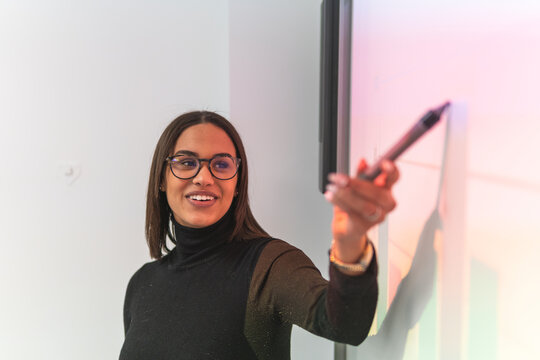Businesswoman explaining on projection screen during meeting at office