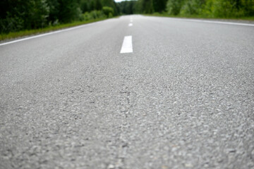 High-speed asphalt highway in the forest during the day