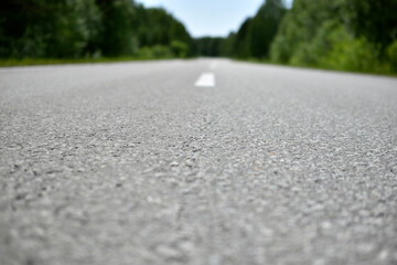 High-speed asphalt highway in the forest during the day