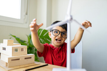 Visually impaired son playing with wind turbine model at home