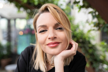 Smiling woman with hand on chin 