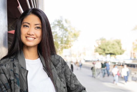 Thoughtful woman with long hair looking away at street