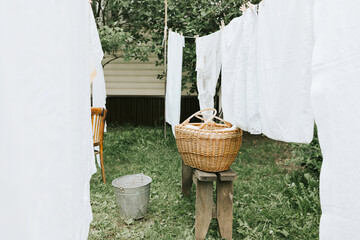 washing clothes in a basin and drying sheets and clothes on the street in the courtyard of a...