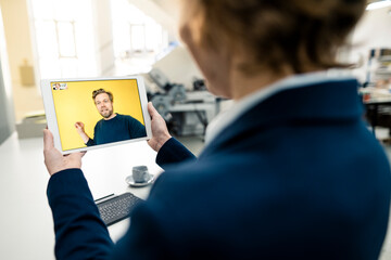 Business people working through video call on digital tablet in industry