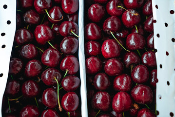 Sweet Cherries on a white wooden box. Fresh juicy red cherry berry rotate. Tasty natural desserts for healthy eating. Raw dessert food with sweet taste