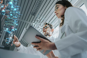 Male and female engineers working on networking projects at industry