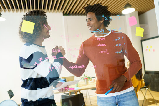 Business colleagues greeting during meeting in office