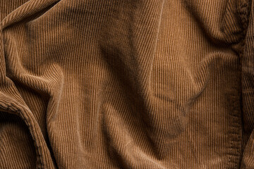 Vintage brown corduroy fabric with seams and creases, shade and contrast areas for backgrounds textures and design, displacement maps, copy space