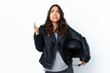 Young woman holding a motorcycle helmet over isolated white background frustrated by a bad situation