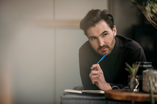 Thoughtful freelance worker looking away while working at home office