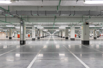 Light gray underground parking without cars, free and empty.