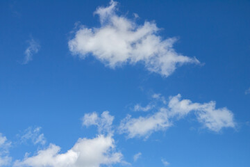 Naklejka na ściany i meble Blue sky with white cumulus clouds on a daytime