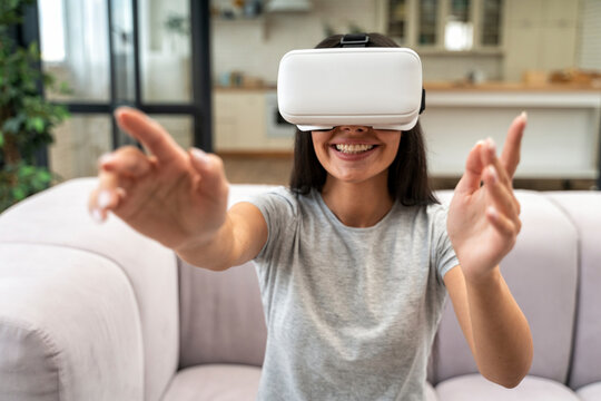 Woman with Virtual reality headset in living room at home