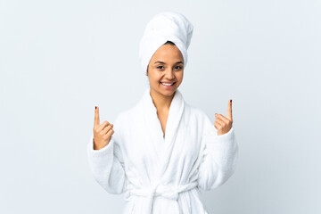 Young woman in bathrobe over isolated white background pointing up a great idea