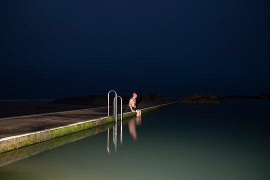 Sportsman sitting at pool during dawn