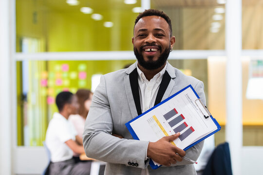 Young businessman with document paper on clipboard at office