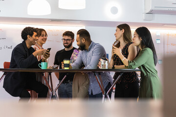 Male and female coworkers talking while taking break at office