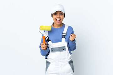 Painter woman over isolated white background celebrating a victory in winner position