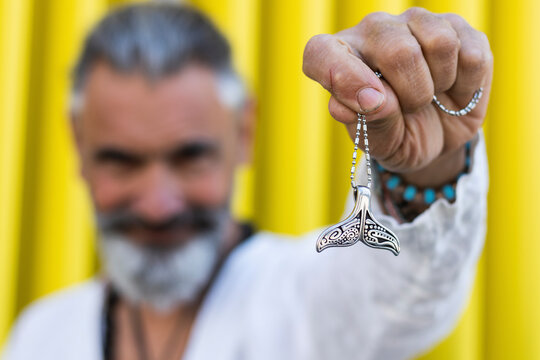 Man showing fish tail locket