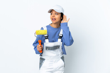 Painter woman over isolated white background listening to something by putting hand on the ear