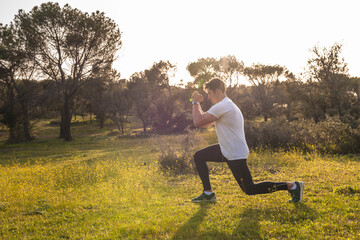 Young athlete exercising on grass area