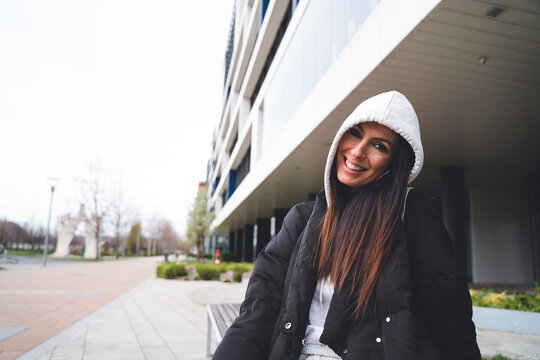Smiling mid adult woman in hood clothing