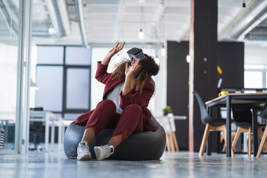Businesswoman gesturing while using virtual reality simulator in office