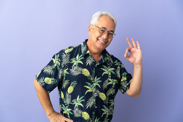 Middle age Brazilian man isolated on purple background showing ok sign with fingers