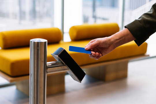 Woman Holding ID Card Near Reader While Entering Office