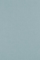 Pale blue colored paper texture. Light gray vertical background. Graceful and refined summer wallpaper. Textured surface, fibers and irregularities are visible. Top-down
