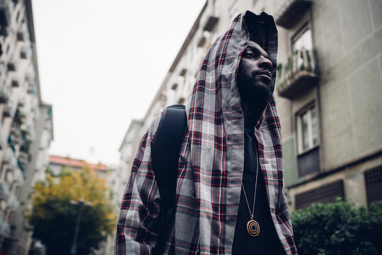 Man wearing hooded jacket looking away
