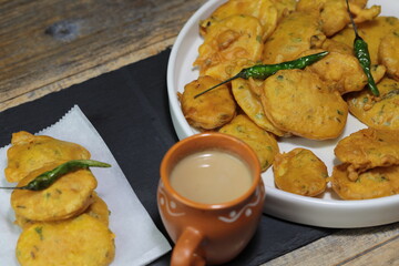 Vegan Aloo Pakora, Aloo Pakoda, Potato Fritters a thin slice of Potato dipped in Gram flour with spices and deep fried.