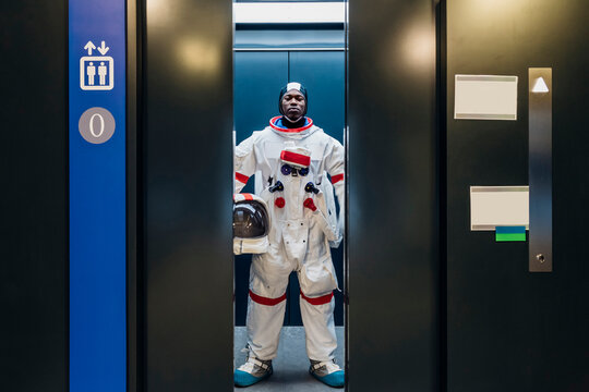 Male astronaut standing in elevator