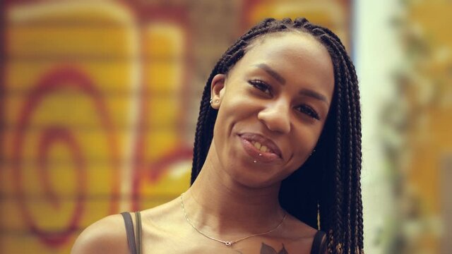 lightheartedness, youth - attractive hispanic woman smiles at the camera