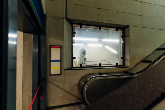Male astronaut seen through glass window