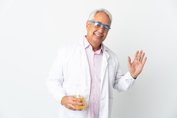 Middle age Brazilian scientific man scientific isolated on white background saluting with hand with happy expression