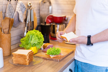 man making sandwich on the kitchen