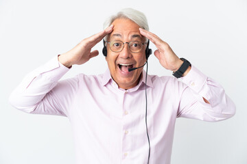 Telemarketer Middle age man working with a headset isolated on white background with surprise expression