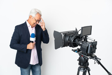 Reporter Middle age Brazilian man holding a microphone and reporting news isolated on white background laughing