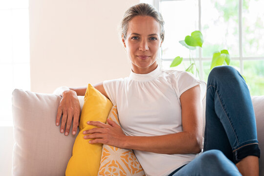 Woman relaxing on couch at home